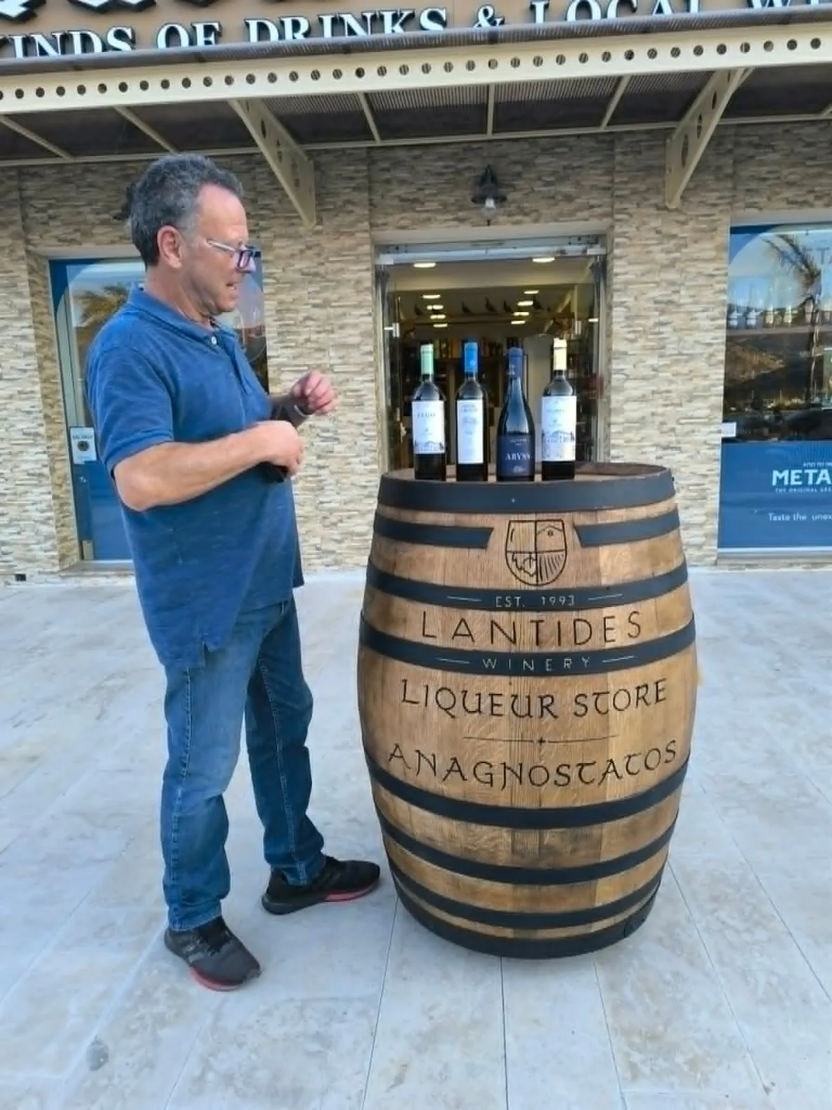 Gerasimos Anagnostatos senior beside the Lantides winery barrel outside the family liquor store in Argostoli.
